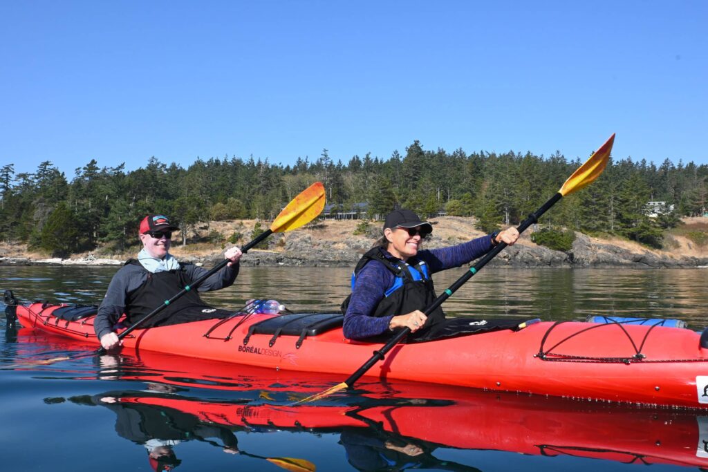 kayak rental friday harbor happy couple | Sea Quest Kayak Tours happy couple paddles a rental kayak in friday harbor