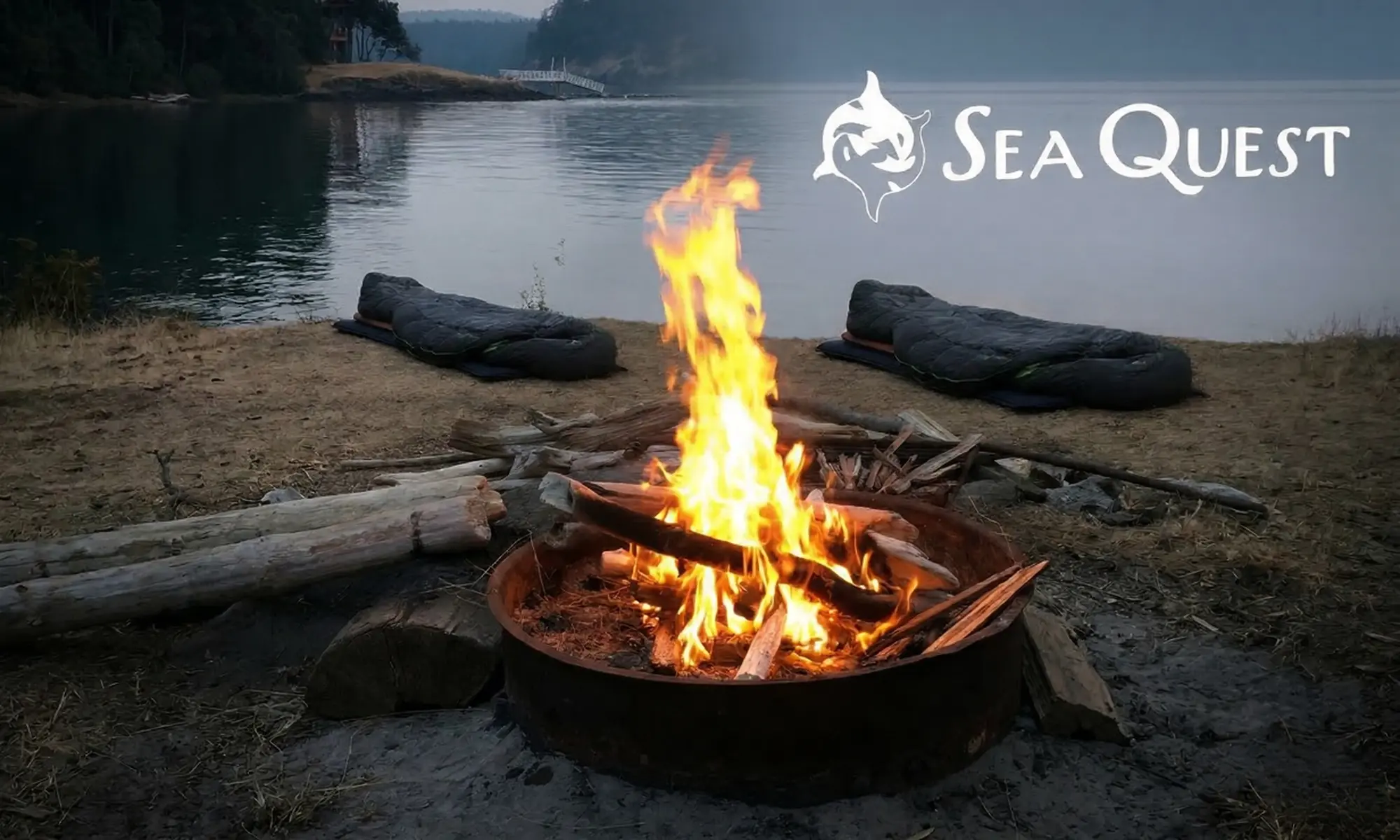 A campfire by the water at dusk near Orcas Island vacation rentals in the San Juan Islands
