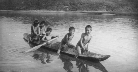 History of Sea Kayaking - Boys Playing with Traditional Kayak