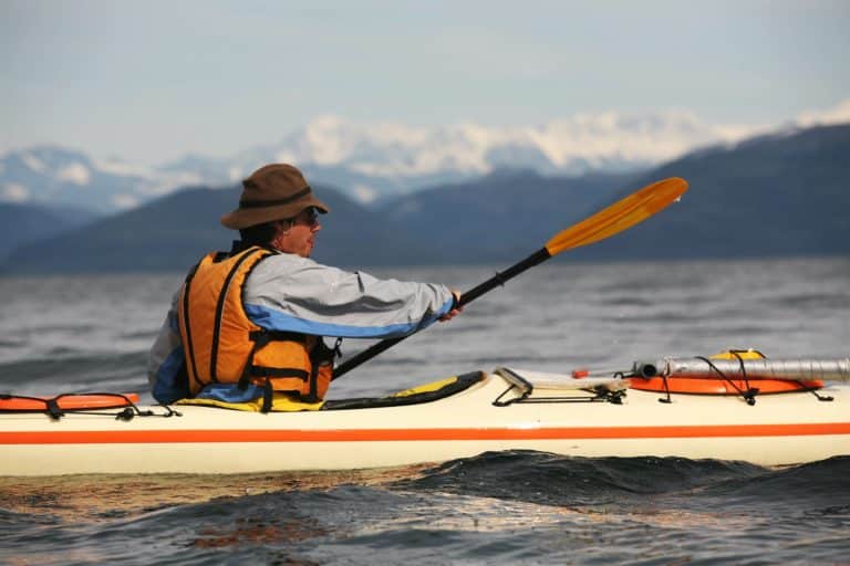 man kayaking in the wilderness alaska